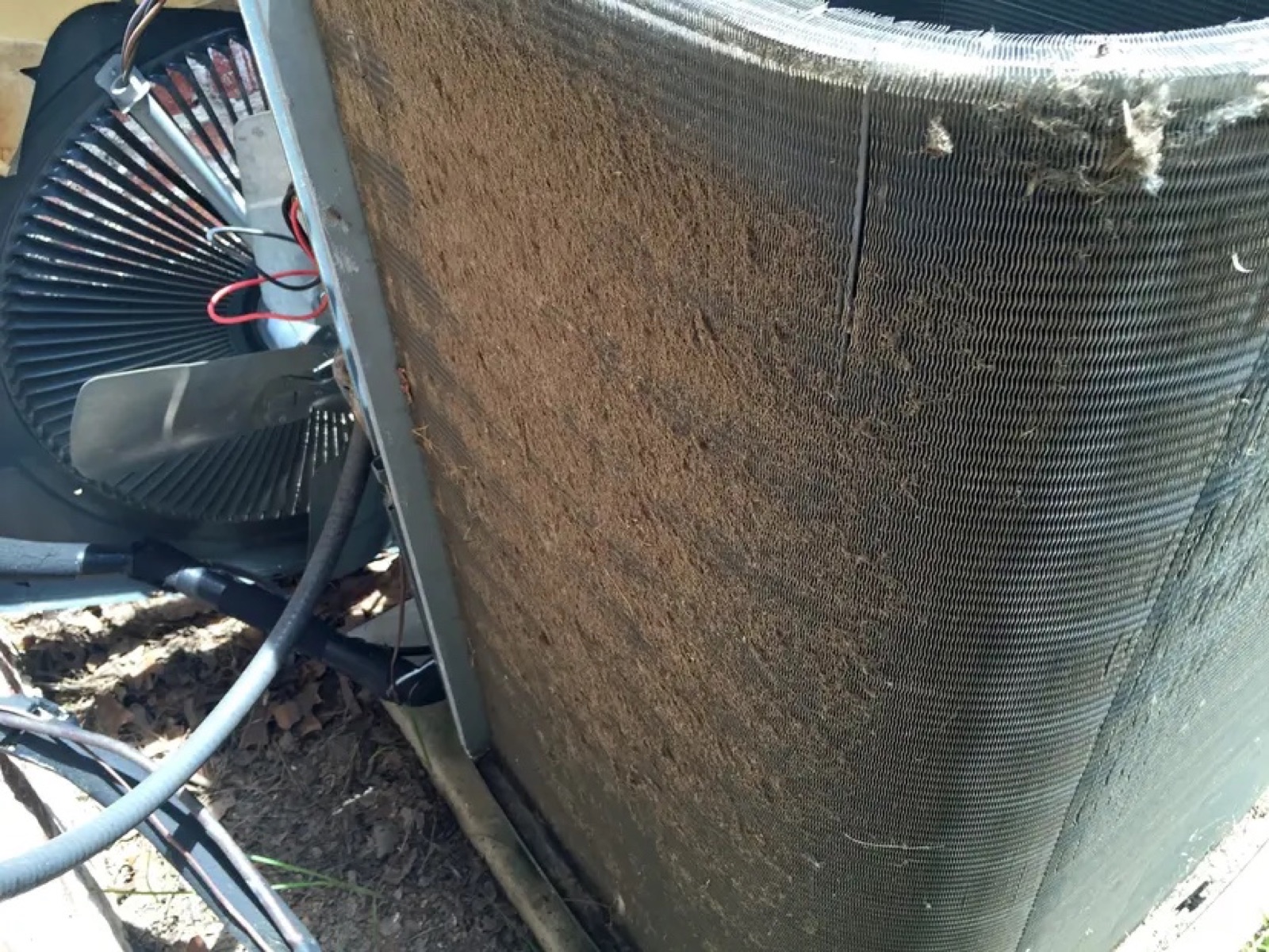 Dust and debris restricting an outdoor condenser coil